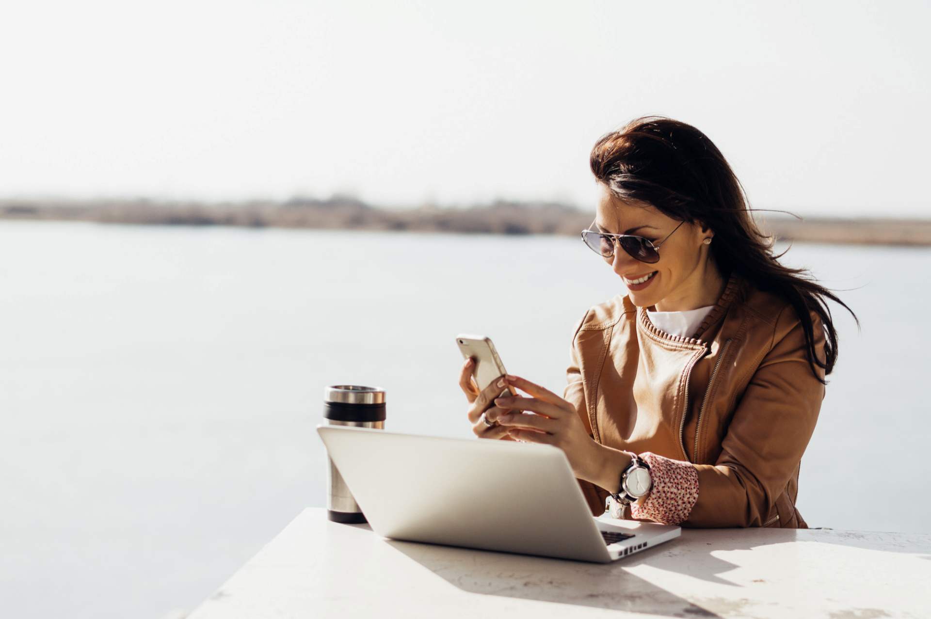 woman with laptop and phone