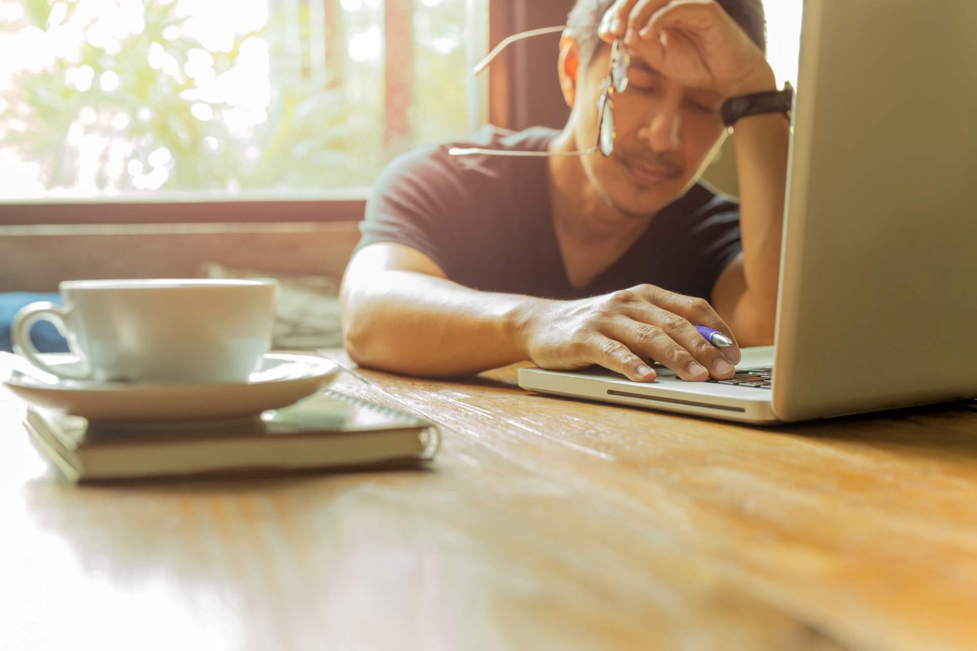 stressed man on laptop